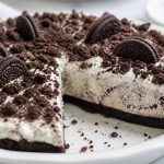 Sliced no-bake Oreo pie with cookie crust and cookies-and-cream filling on a dessert plate