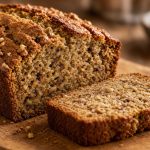 Sliced banana bread loaf with a moist crumb and a crack down the top