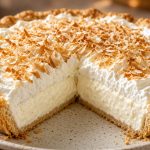 Coconut cream pie with toasted coconut and whipped cream