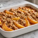 Peach crisp with an oat topping in a baking dish